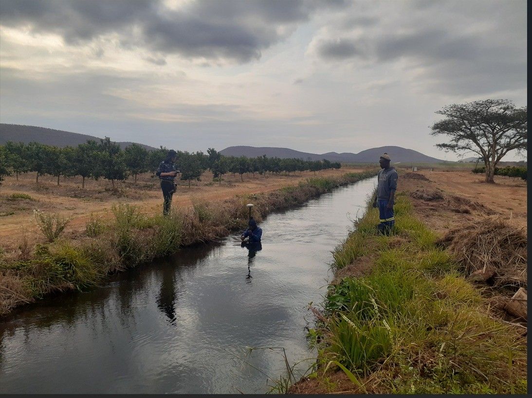 Surveyors working along a canal