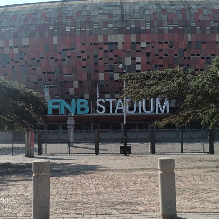 The outside of FNB Stadium with its name sign