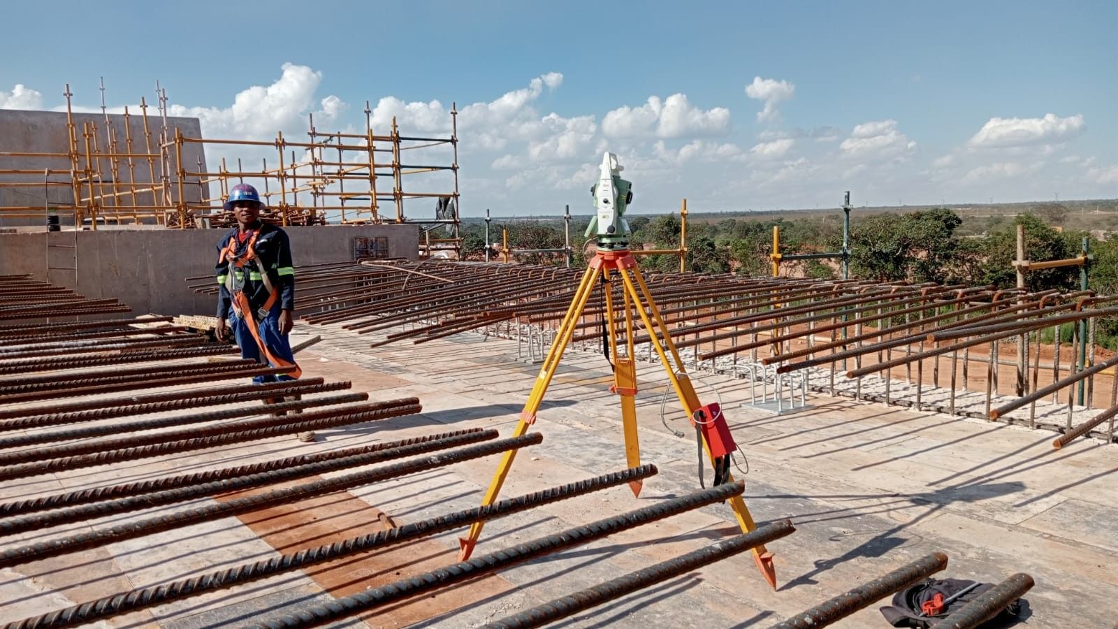 A surveyor with a total station on a reinforcing steel deck