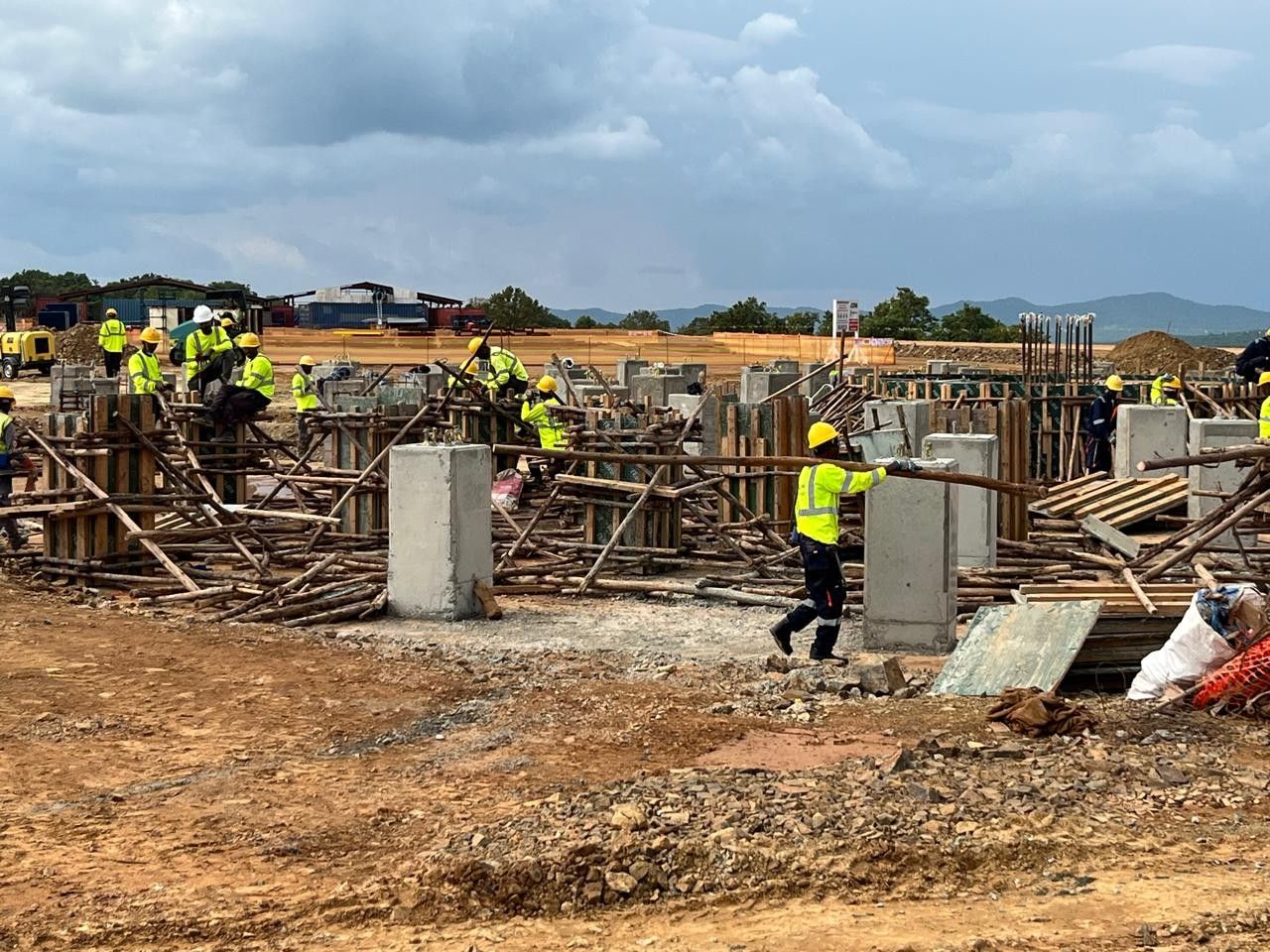 Surveyors among reinforcing steel and foundations at the Kurmuk plant site