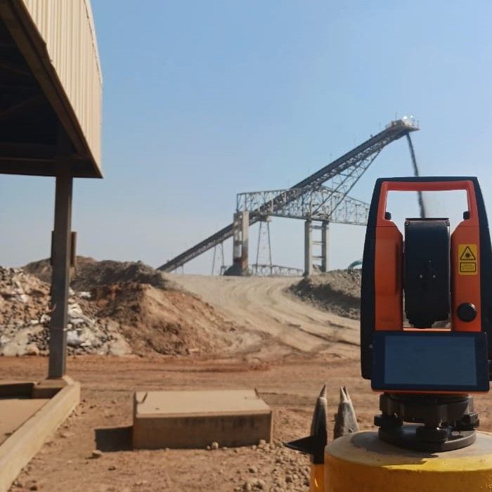 A total station set up near a conveyor at Lumwana Mine