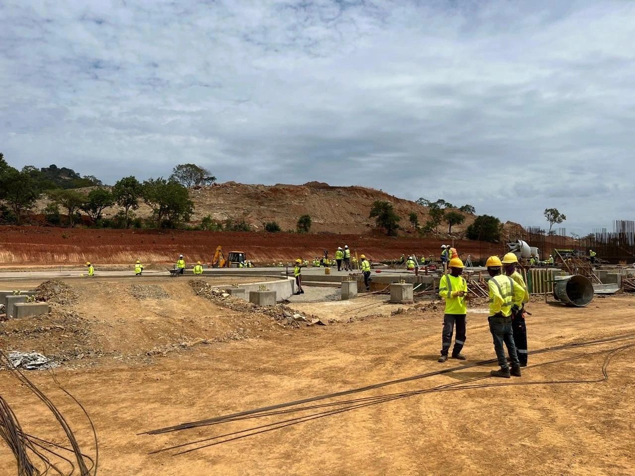 A survey crew walking across an earthworks site