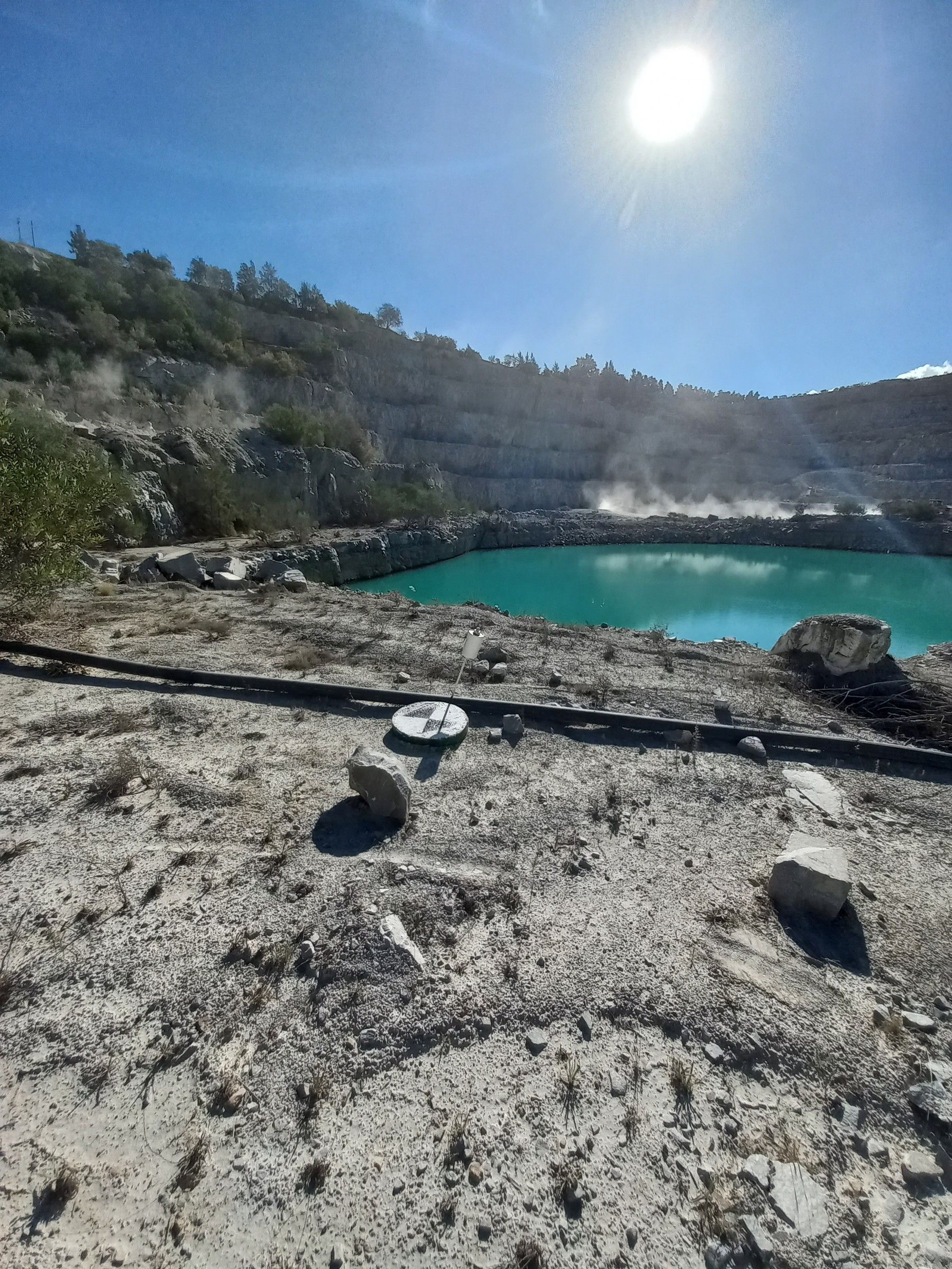 A pit lake seen from the edge of an open pit
