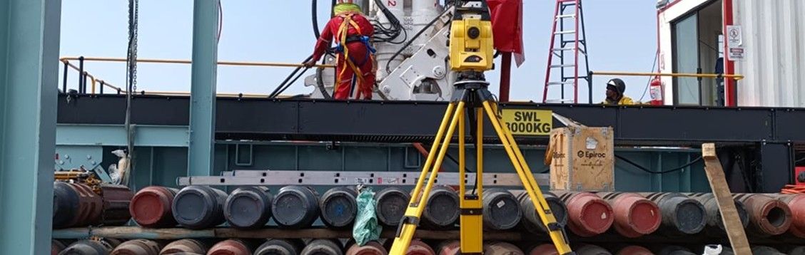 A total station set up beside conveyor equipment at Namakwa Sands