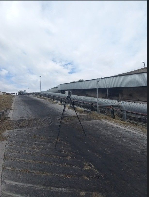 A laser scanner on a tripod on an industrial platform