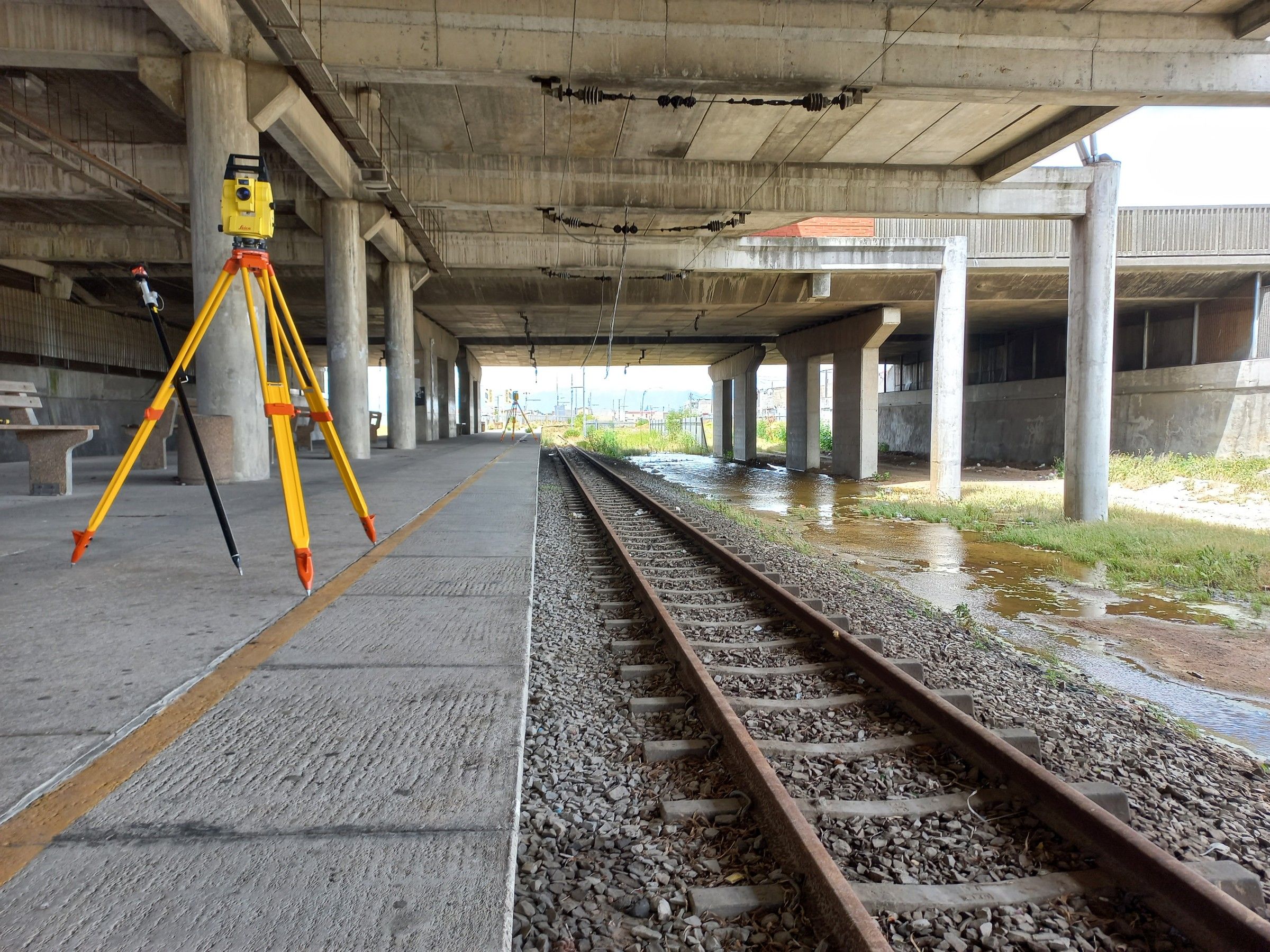 A total station set up on a railway station platform